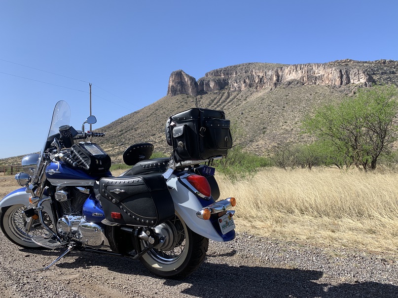 Motorcycle parked along Arizona Route 82 with mountains behind it